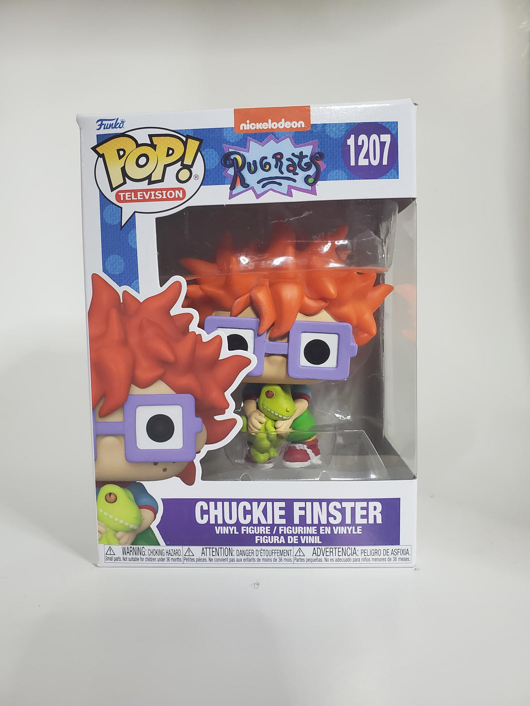 Chuckie Finster holding Reptar Funko POP.